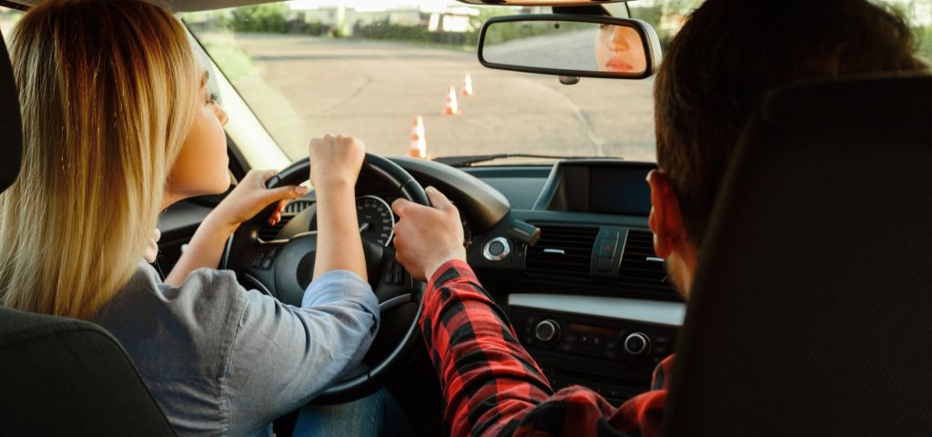 instructor-helps-woman-to-drive-the-car-1.jpg